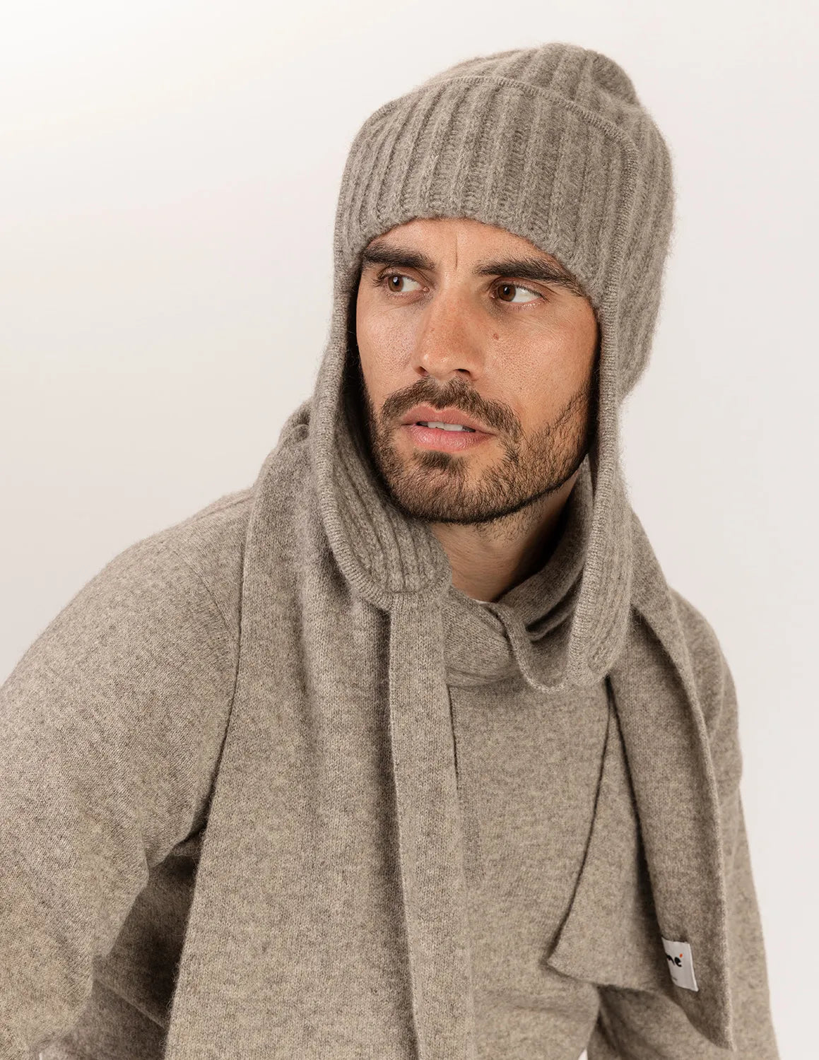 Nomé male model wearing sweater and scarf