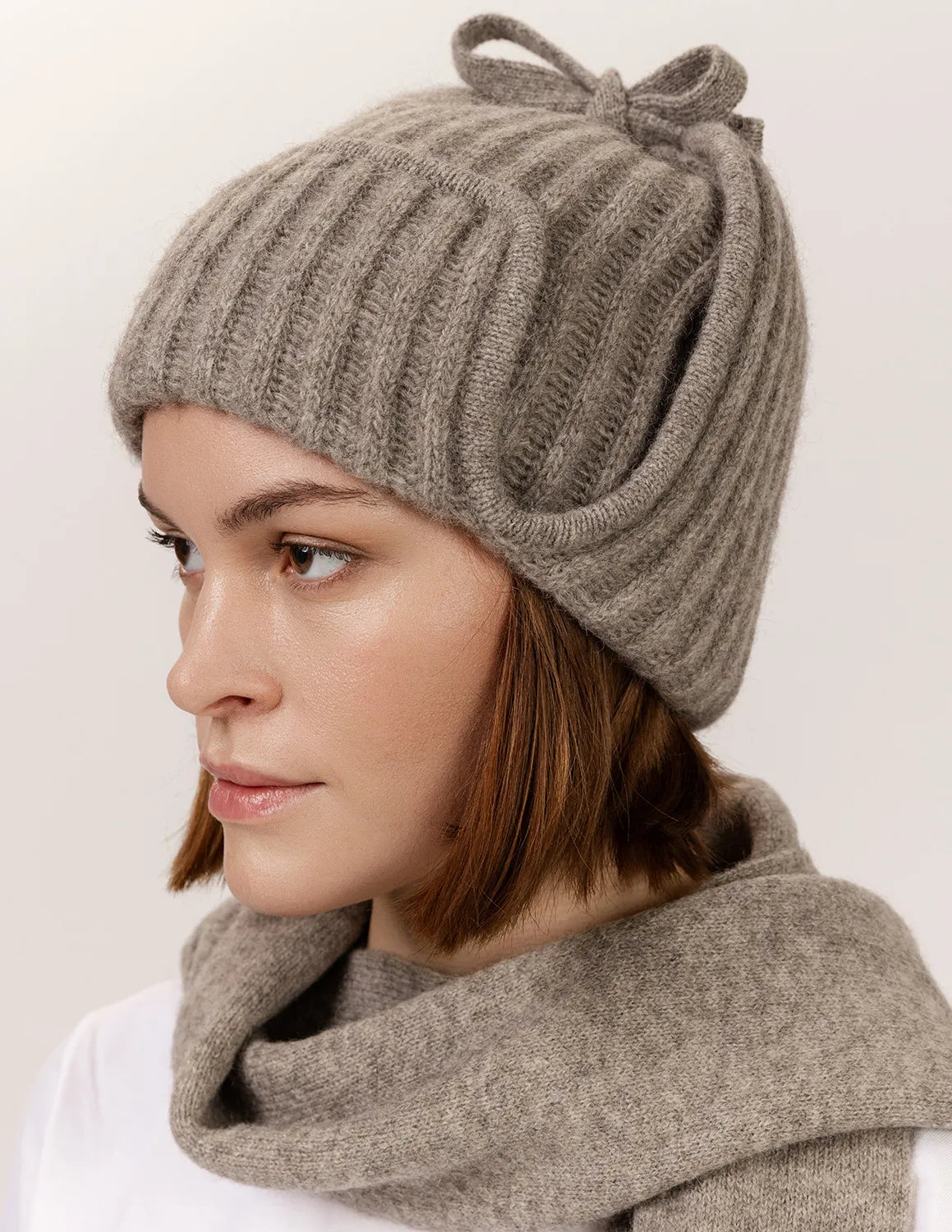 Woman wearing a gray knit hat and scarf on a white background - Natural Grey