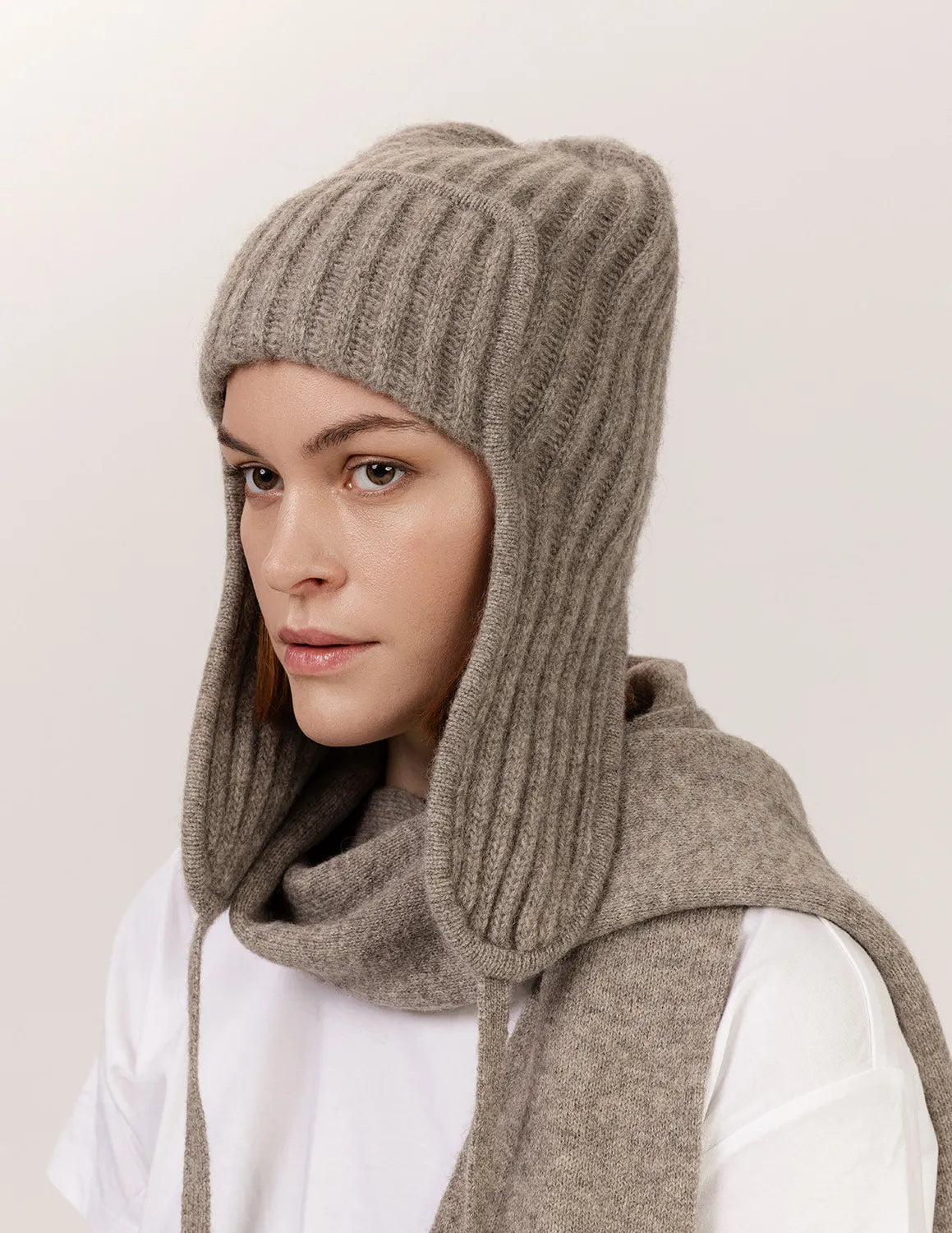 Person wearing a brown knitted hood over a white shirt on a light background - Natural Grey