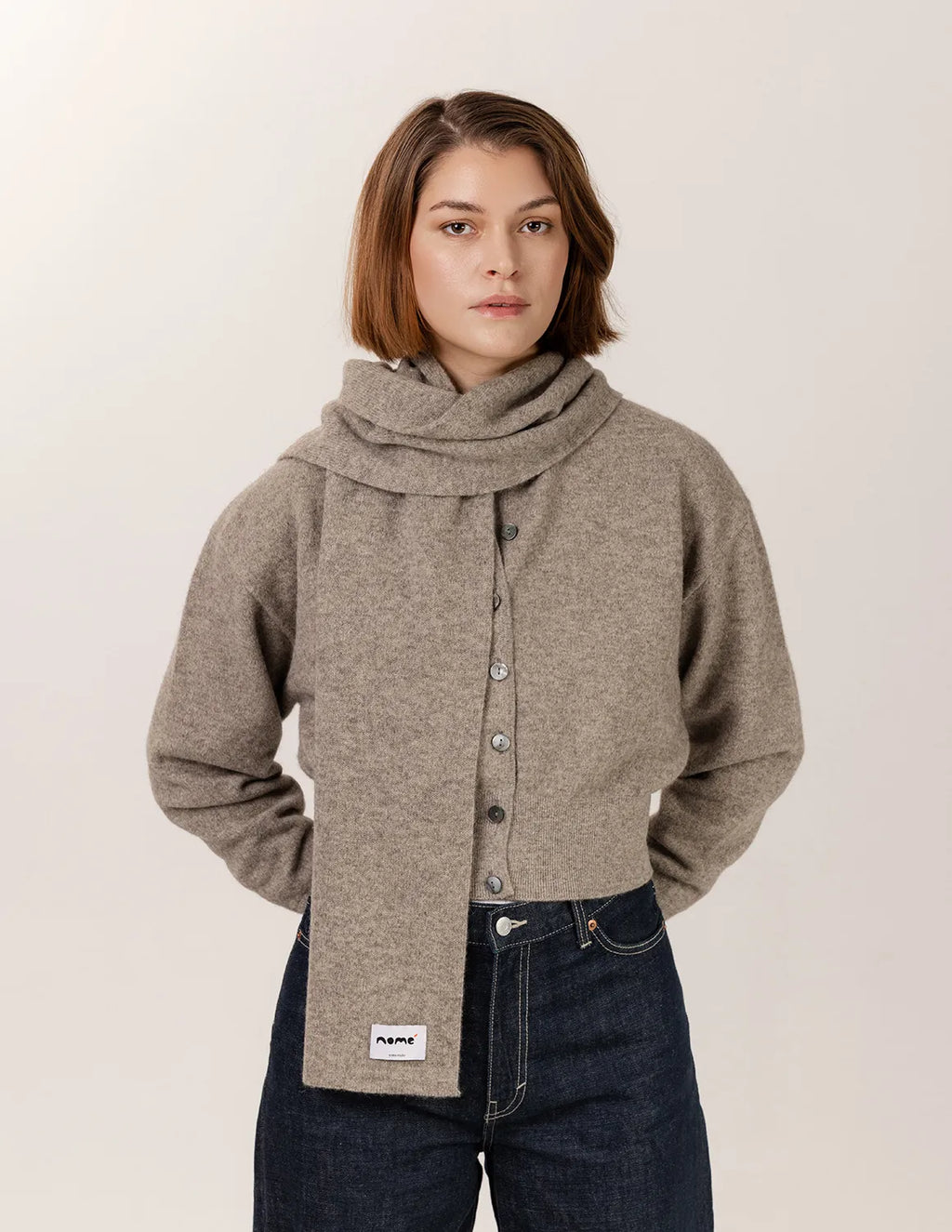 Woman wearing a brown button-up shirt with a collar against a plain background Natural Grey