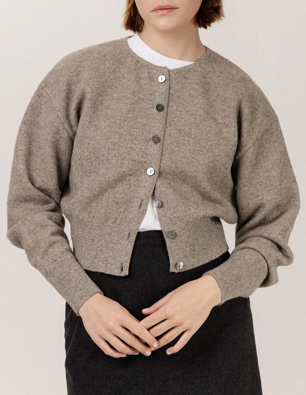 Person wearing a brown cardigan over a white shirt with a plain background - Natural Grey