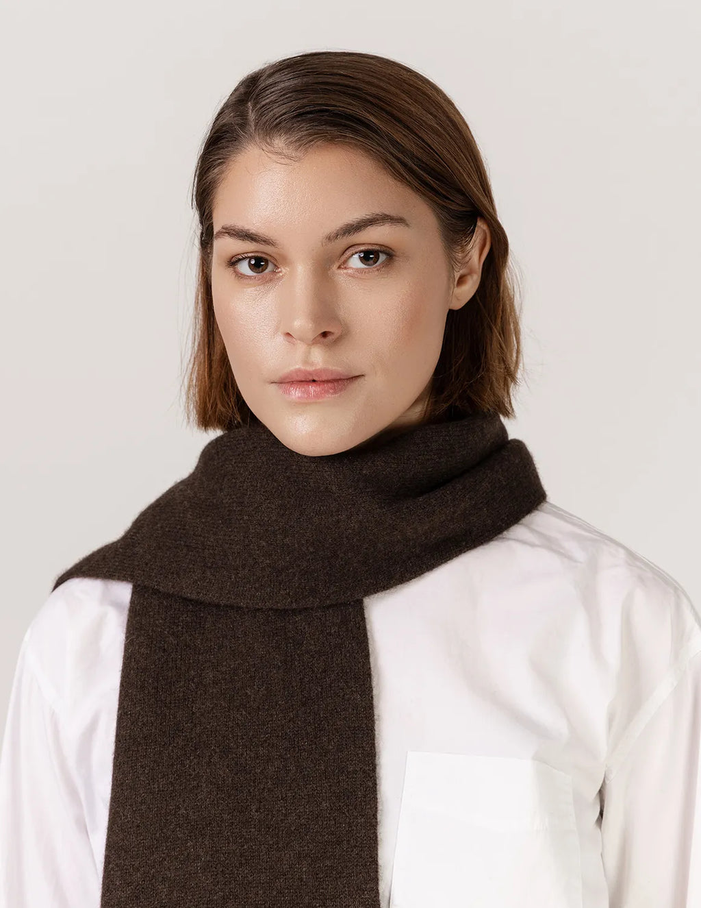 Woman wearing a brown scarf against a plain background - Natural Brown