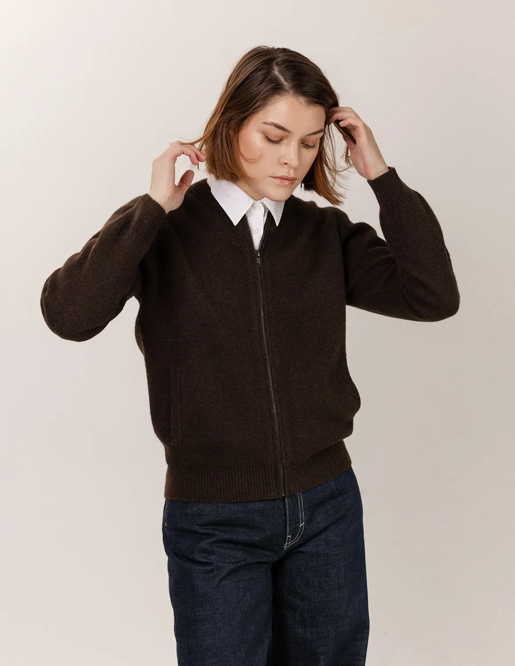 Person wearing a brown sweater over a white shirt with a plain background - Natural Brown
