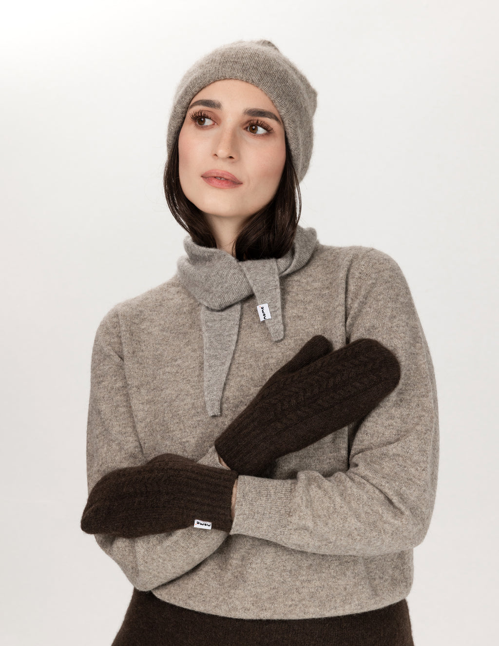 A woman wearing Nomé Guna scarf along with other Nomé garments - Natural Grey