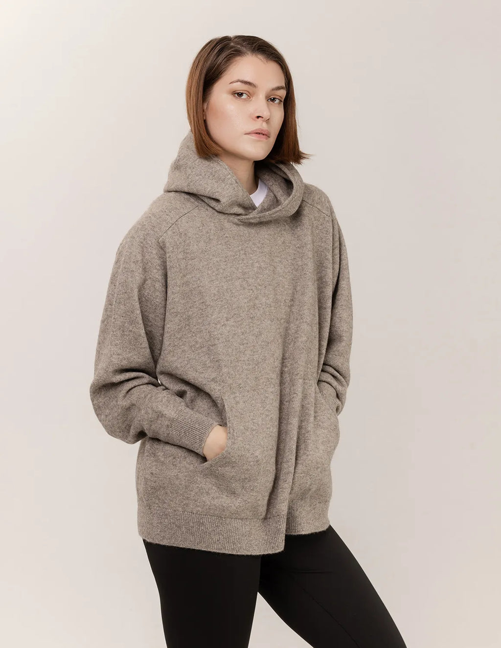 Woman wearing a gray hoodie against a plain background - Natural Grey