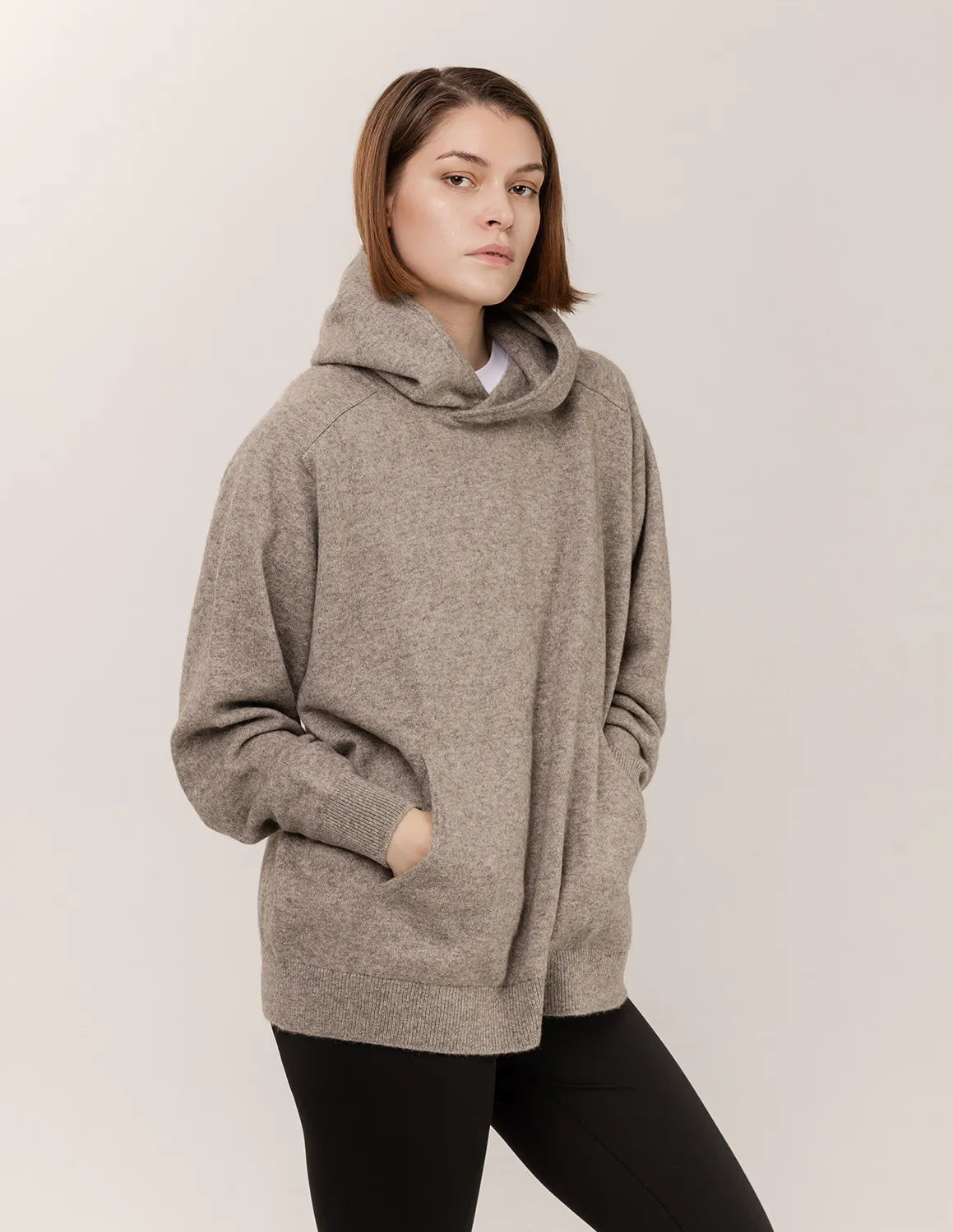 Woman wearing a gray hoodie against a plain background - Natural Grey