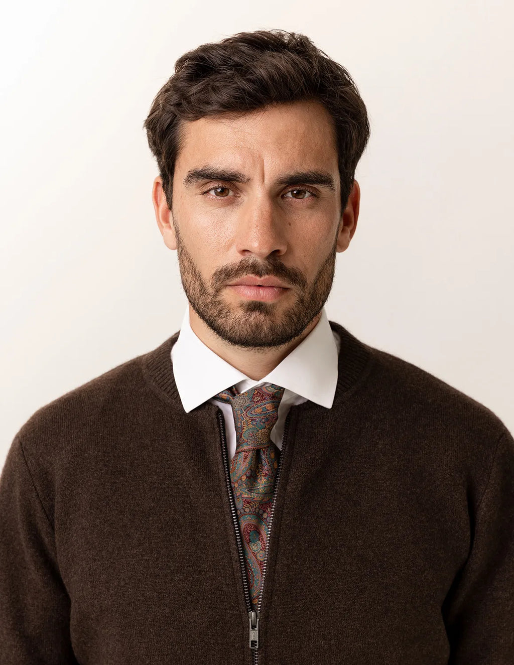 Man wearing a brown sweater with a patterned tie against a white background - Natural Brown