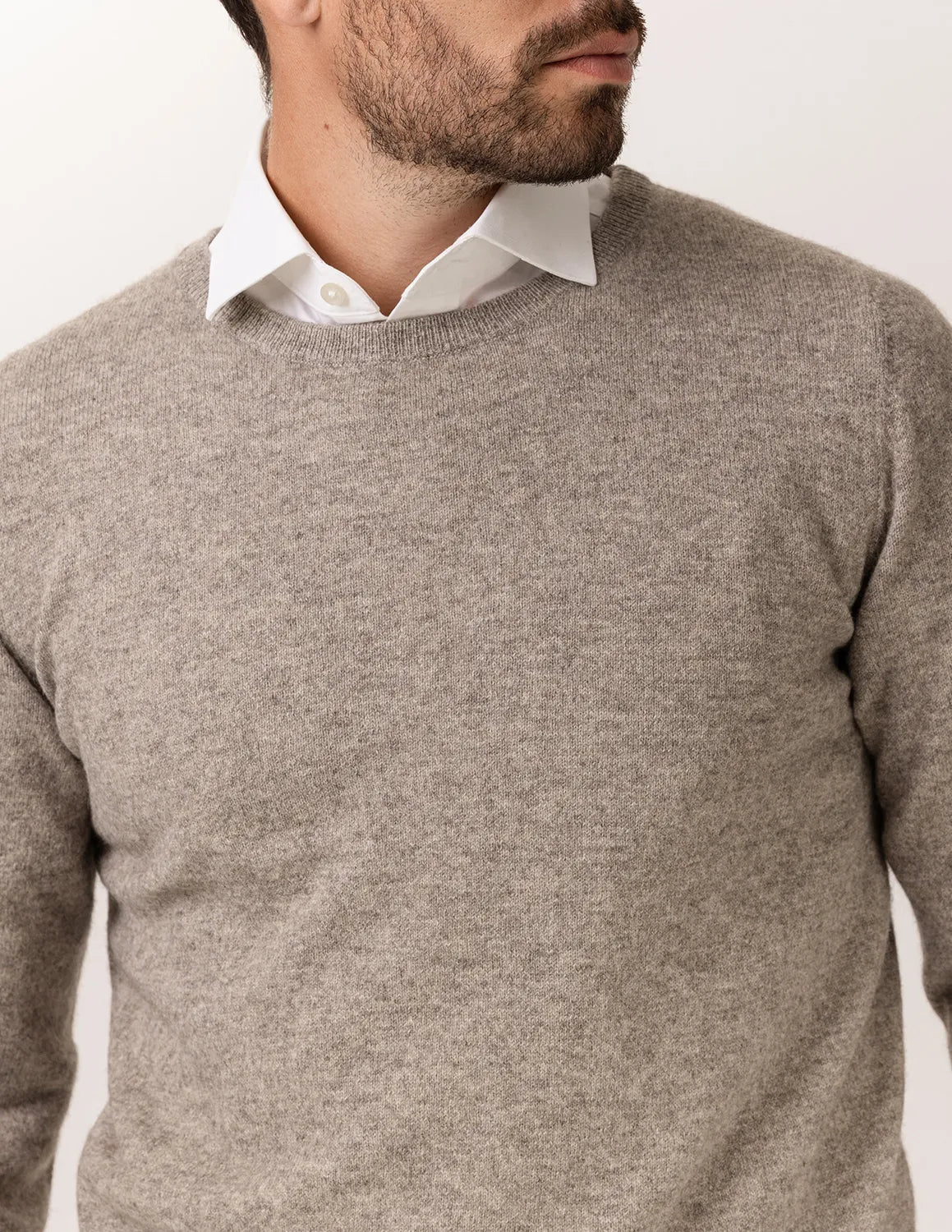 Man wearing a beige sweater over a white shirt on a plain background - Natural Grey
