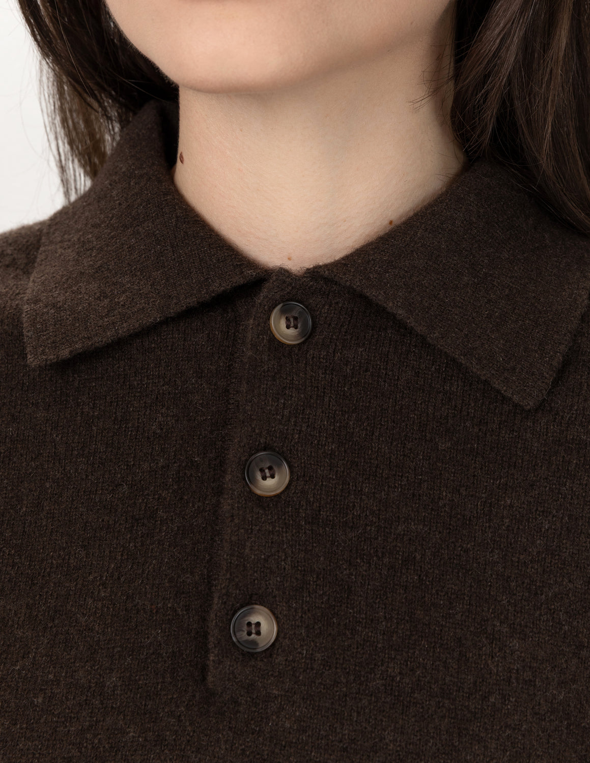 Close-up of a person wearing a dark brown knit polo shirt with a collar and three dark buttons - Natural Brown