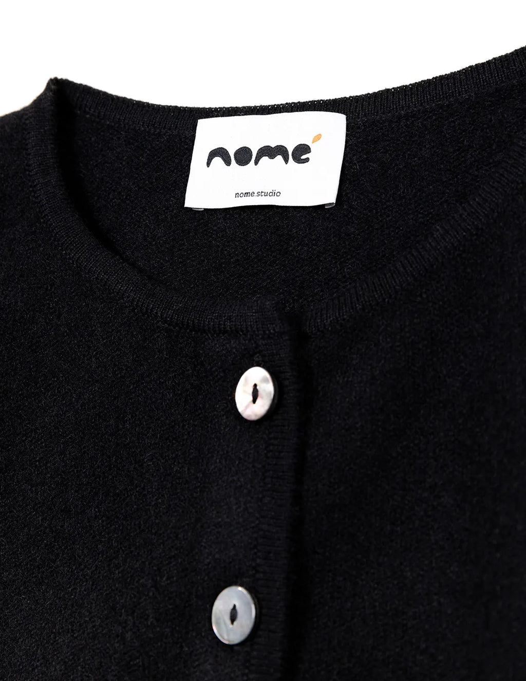 Black garment with white buttons and a visible brand label on a white background - Black