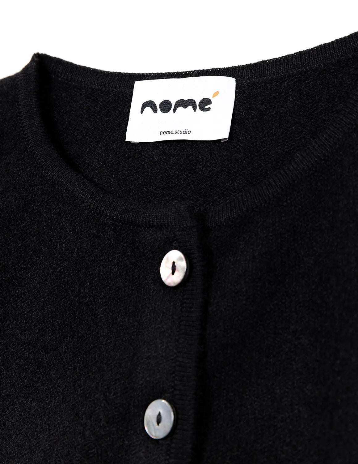 Black garment with white buttons and a visible brand label on a white background - Black