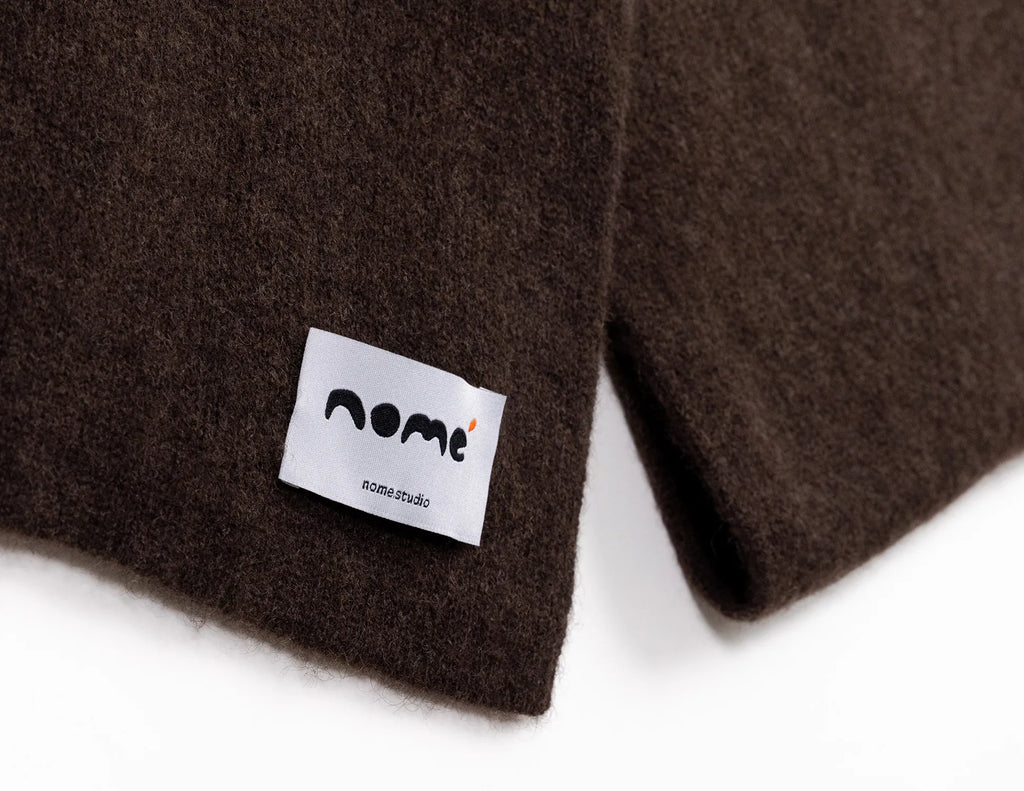 Brown fabric with a white label featuring the 'nome' logo on a white background - Natural Brown