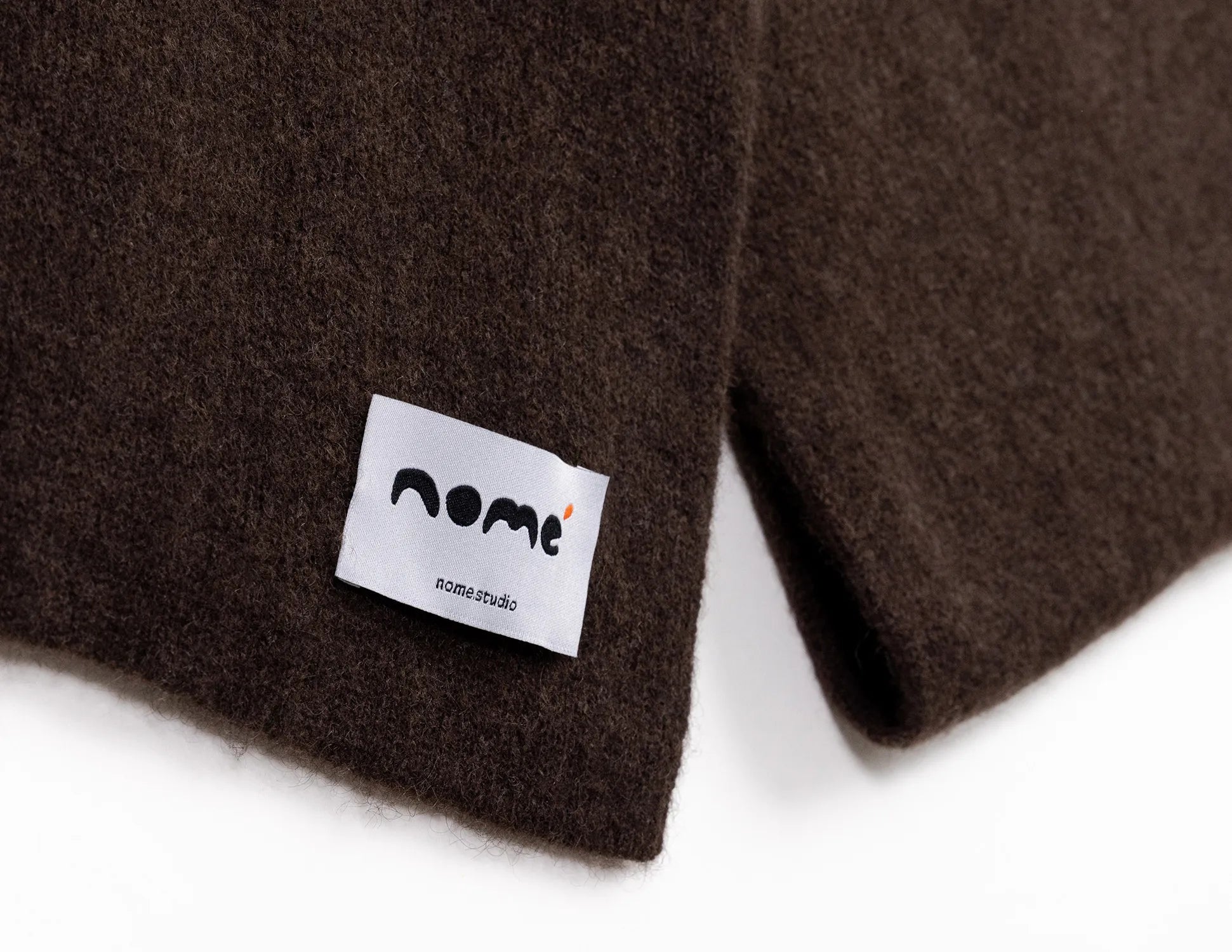 Brown fabric with a white label featuring the 'nome' logo on a white background - Natural Brown