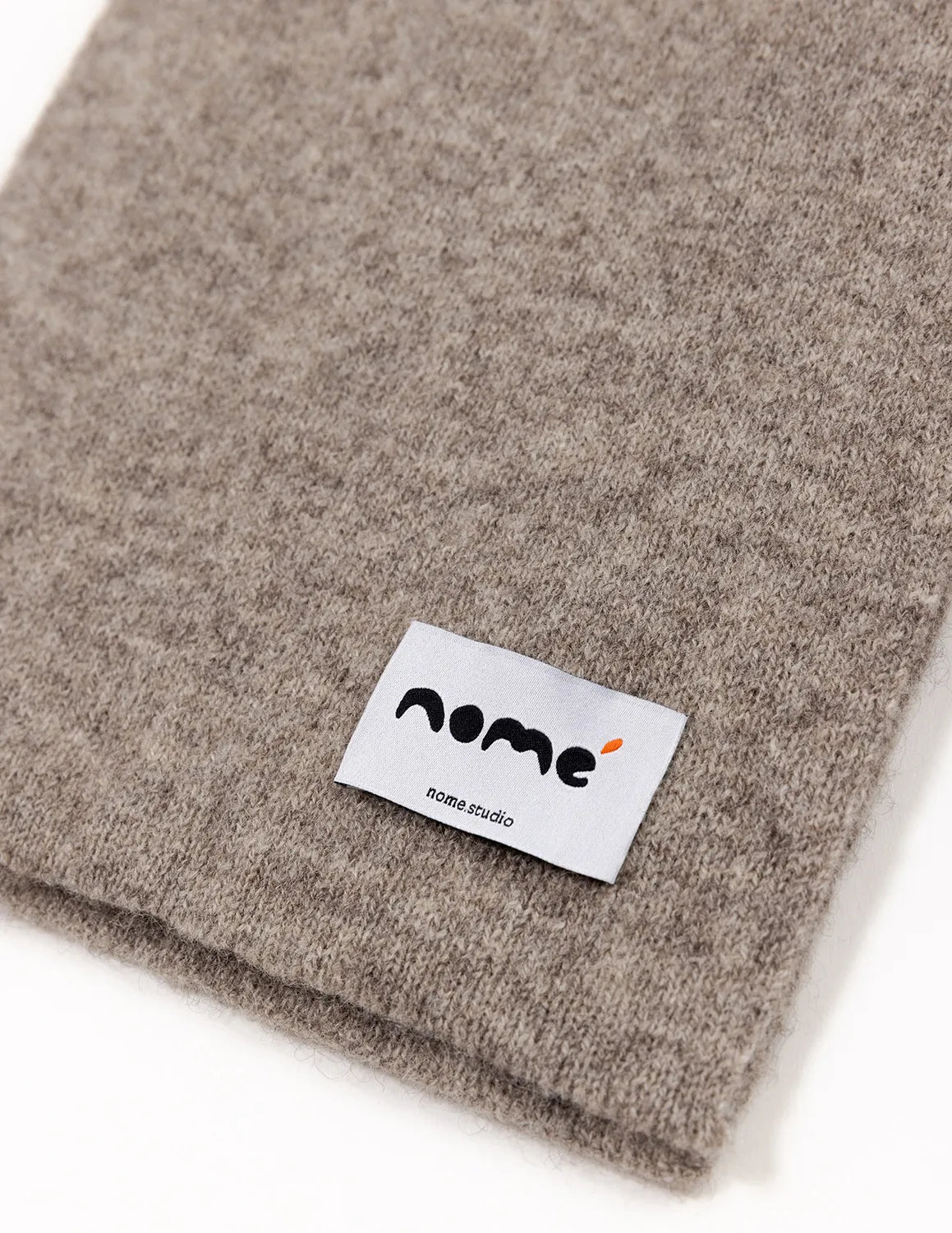 Gray fabric with a 'nome' label on a white background Natural Grey